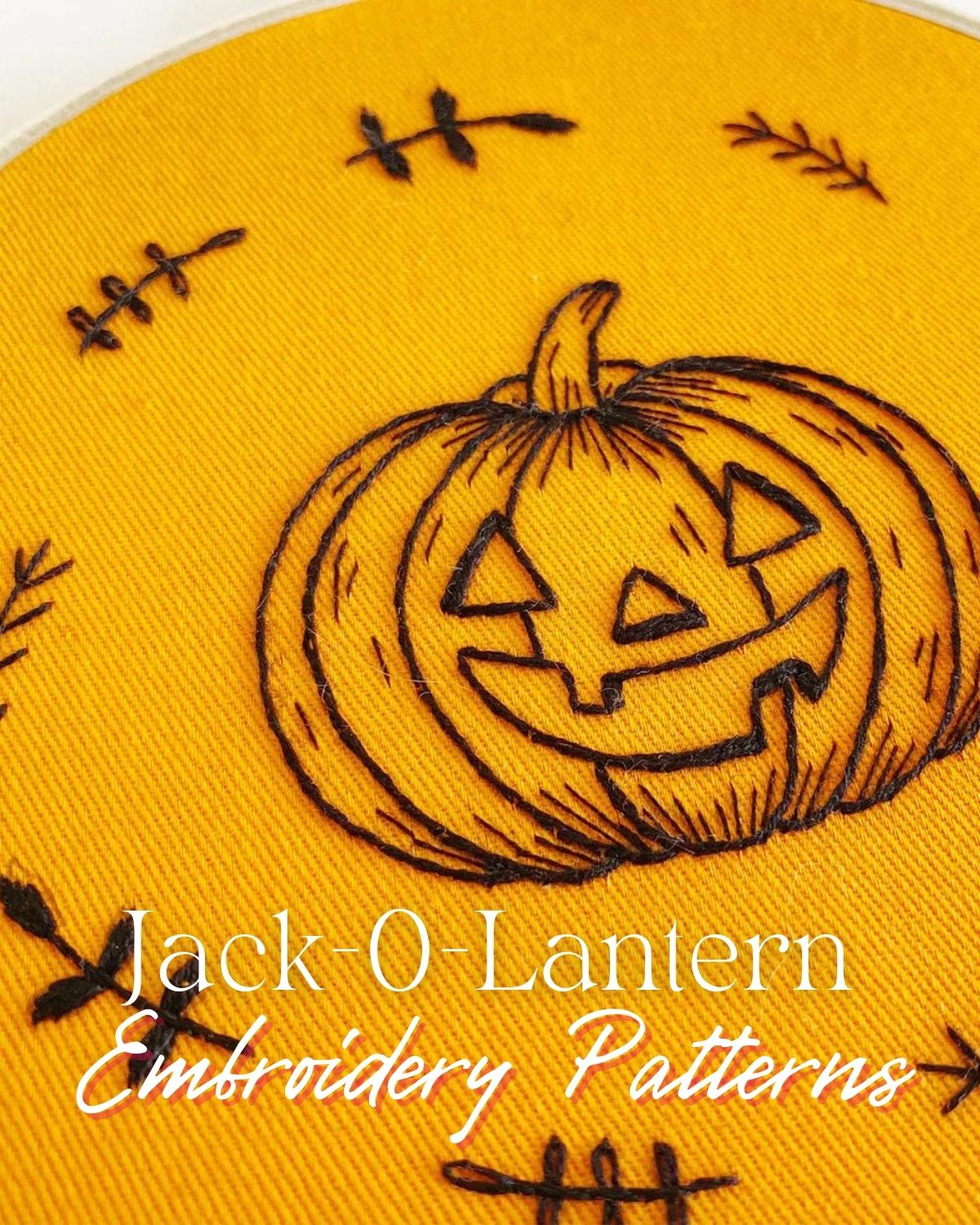 A jack-o-lantern embroidery piece with black thread on orange background