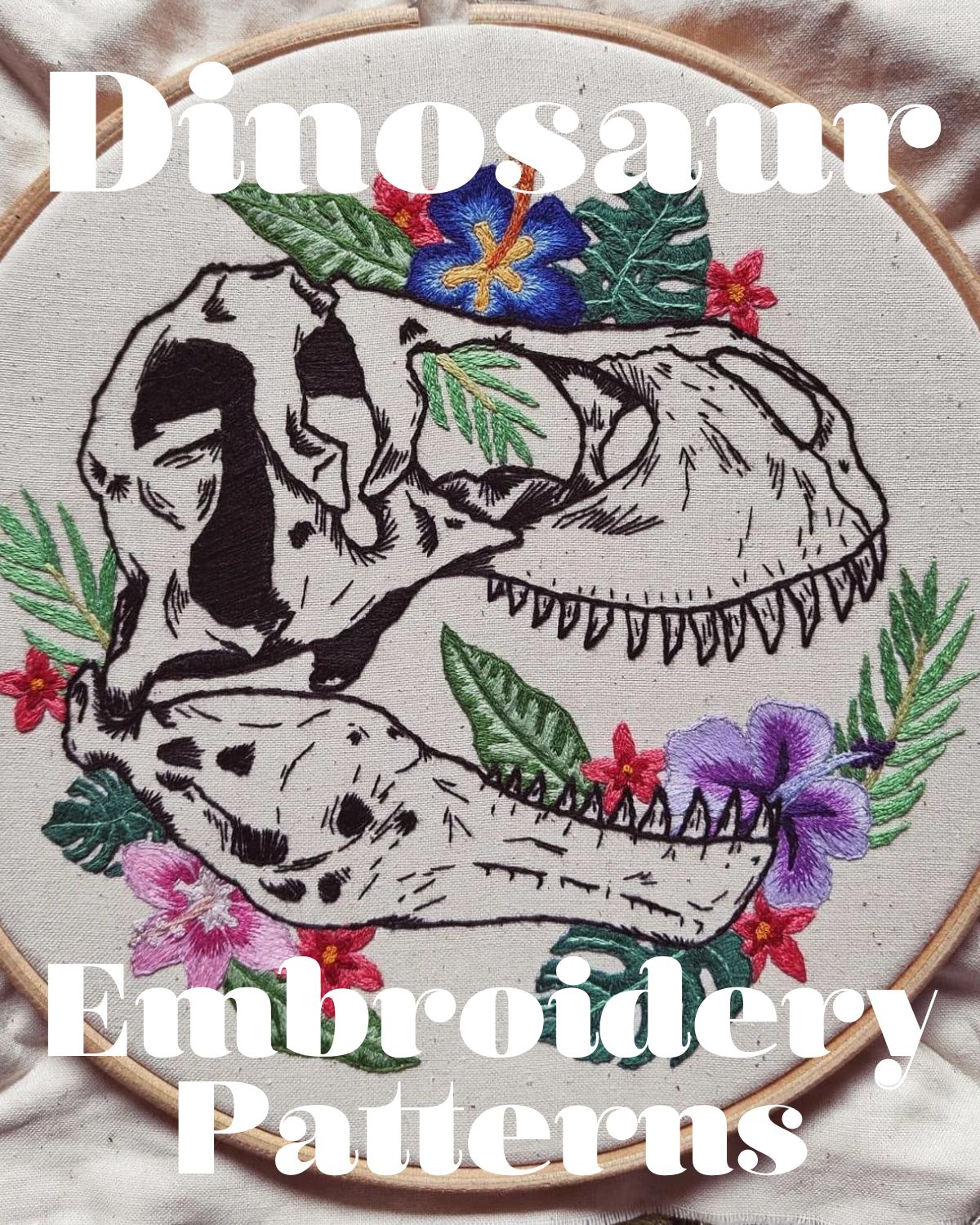 An embroidery hoop with a stitched dinosaur head and florals 